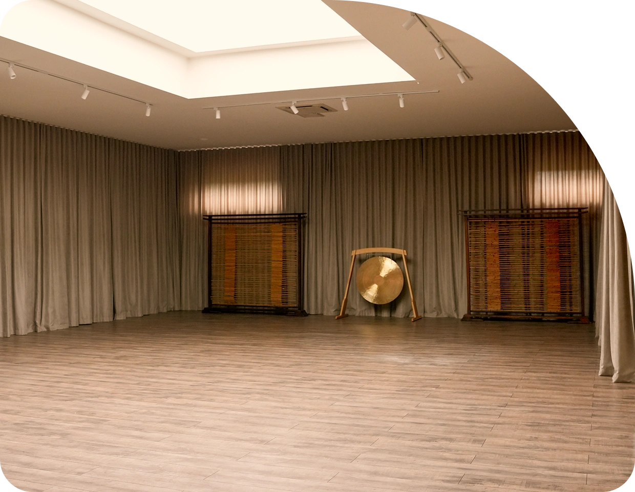 The yoga room at Magic Bali Spa with a gong and a wooden floor
