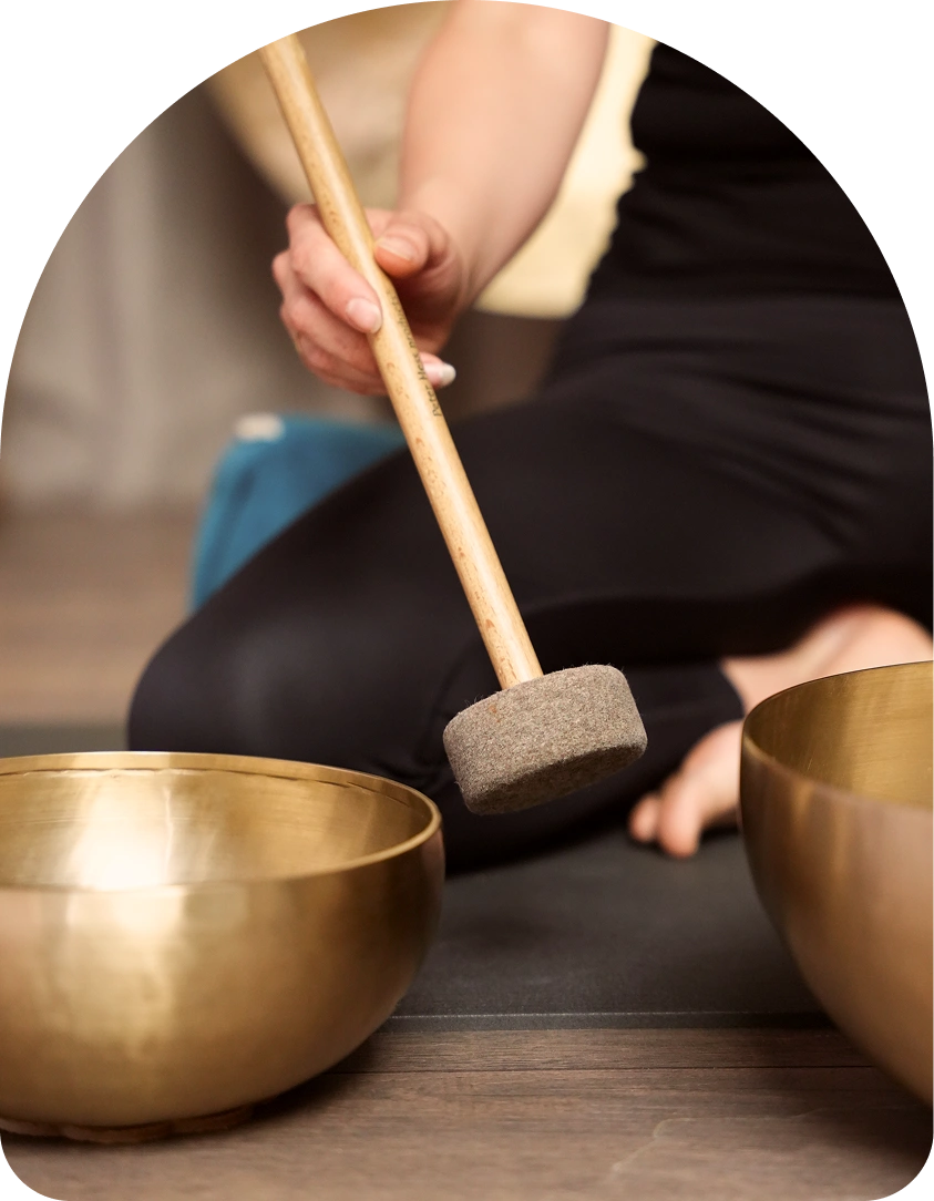 Playing Tibetan singing bowls during a yoga class